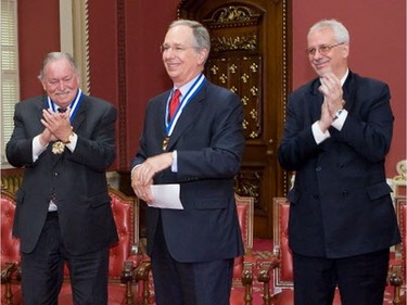 Daniel Johnson Jr. is applauded by Jacques Parizeau and brother Pierre Marc Johnson during a ceremony in the Red room of the National Assembly in Quebec City, in 2008, where they received the Insigne de Grand Officier along with former premiers Bernard Landry and Lucien Bouchard. The Johnson patriarch, Daniel Johnson Sr. (not shown), was also a Quebec premier and shared the same alma mater as his sons.