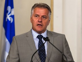 Quebec Transport Minister Laurent Lessard is sworn in during a cabinet shuffle at the legislature in Quebec City on Saturday, August 20, 2016.