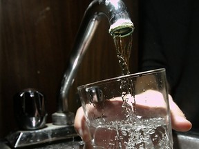 Pouring a glass of tap water.