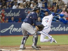 Toronto Blue Jays' Melvin Upton Jr. (right) slides into home plate in front of Minnesota Twins catcher Kurt Suzuki after Justin Smoak hit an RBI single off Minnesota Twins starting pitcher Pat Dean during third inning Major League baseball action in Toronto on Friday, August 26, 2016.