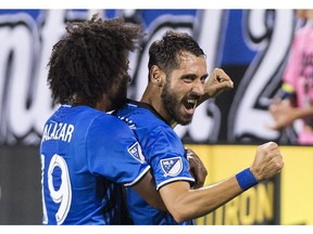 Impact striker Matteo Mancosu, right, celebrates with teammate Michael Salazar after scoring winning goal against the Houston Dynamo during MLS action at Montreal's Saputo Stadium on Aug. 6, 2016. The Impact won the game 1-0.