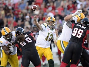 Edmonton Eskimos quarterback Mike Reilly (13) throws the ball during first half CFL action against the Ottawa Redblacks on Saturday, Aug. 6, 2016 in Ottawa.