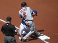 Brian Dozier of the Minnesota Twins advances safely from second base to third base on a fly out in the first inning during MLB game action as he gets tangled up with Josh Donaldson of the Toronto Blue Jays at third base on Saturday, August 27, 2016, at the Rogers Centre in Toronto.