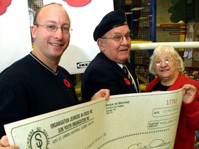 In this file photo, at the IKEA store on Cavendish Blvd. In Ville St-Laurent, Tommy Kulczyk (left) from Sun Youth Organization, presents a $3,000 check for their poppy drive to the Royal Canadian Legion Branch 98's Leo Lehman M.M. along with Freda Kopyto a volunteer at Sun Youth.