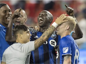 Montreal Impact players celebrate defeating Toronto FC in their MLS game in Toronto on Saturday, Aug. 27, 2016.