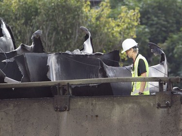 A worker inspects the scene of Tuesday's fatal truck crash and fire on highway 40 west at Lajeunesse in Montreal, Wednesday August 10, 2016. The 40 westbound remains closed.
