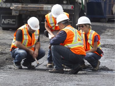 Transport Québec workers inspect the road at the scene of a fatal truck crash.