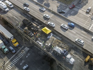 Workers inspect the scene of Tuesday's fatal truck crash and fire on highway 40 west at Lajeunesse in Montreal, Wednesday August 10, 2016. The 40 westbound remains closed.