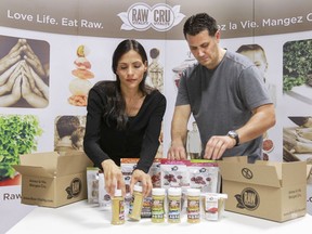 Dimitri Tsatoumas and wife/partner Georgia Siounis arrange a display of their Raw Vitality raw food products at their production facility.