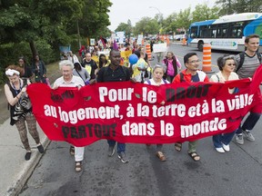 Protesters march along Van Horne Ave. in Côte-des-Neiges Friday August 12, 2016, during a demonstration to demand better social housing in the province and the rest of the country.