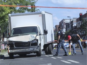 Police investigate at the scene of an accident on Parc Ave. Tuesday, August 2, 2016 after a panel truck (left) hit two pedestrians leaving them both in critical condition. This happened in the mid-afternoon at the intersection of Bernard Ave.
