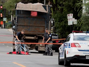 Police investigators reconstruct the scene of of an accident between a cyclist and a dump truck in Rosemont Aug. 22, 2016.