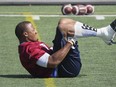 MONTREAL, QUE.: August 24, 2015 -- Montreal Alouettes defensive end John Bowman stretches during practice in Montreal Monday August 24, 2015. (John Mahoney / MONTREAL GAZETTE)