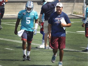 Alouettes offensive coordinator Anthony Calvillo is all smiles while walking on the field with quarterback Kevin Glenn during Alouette's practice at Stade Hébert in St-Léonard on August 24, 2016.