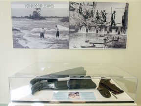 Photos and a display of raftmen's thigh-high boots and socks are part of a new exhibit at the Dorval Museum in Dorval. The exhibit explores the history of the Lachine Rapids.  (John Mahoney / MONTREAL GAZETTE)
