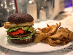 Jukebox Burgers'  Georgia Burger features  a minced beef and herbed chorizo blended half-pound patty, fresh baby arugula, homemade garlic yogurt spread, avocado, caramelized onions, roasted bell pepper and fried and flambéed Mediterranean table cheese, served on a pumpernickel bun.


from  restaurant in DDO, in the West Island of Montreal on August 25, 2016.The ingredients are AAA minced beef and herb chorizo blended 1/2 lb patty served on a bed of fresh baby arugula with a homade garlic yogurt spread topped with avocado, caramelized onions, roasted bell pepper and fried and flambeed Mediterranean table cheese, all between a freshly baked pumpernickel bun. Fifth Burger Week is an event which will take place from September 1 to 7 with the participation of close to 50 restaurants in Montreal and 150 more elsewhere.The mandate is to create burgers especially for the week.  (Marie-France Coallier/ MONTREAL GAZETTE)  ORG XMIT: 56960