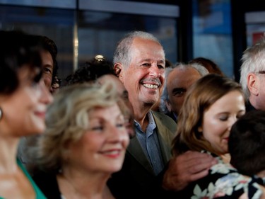 Denys Arcand poses for a group picture with other members of the cast and crew outside the Imperial Cinema Thursday, Aug. 25, 2016 for the première of Quebec director André Forcier's Embrasse-moi comme tu m'aimes, the opening film of the Festival des films du monde.