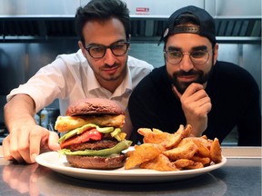 Le Burger Week co-founders Thierry Rassam, left, and Na'eem Adam inspect a Georgia Burger at Jukebox Burgers restaurant — one of the dozens of establishments taking part in the fifth edition of Le Burger Week, which starts Thursday, Sept. 1.