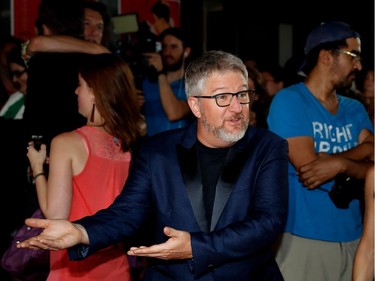 Comedian and actor Benoît Brière jokes with photographers on the red carpet outside the Imperial Cinema Thursday, Aug. 25, 2016 for the première of Quebec director André Forcier's Embrasse-moi comme tu m'aimes, the opening film of the Festival des films du monde.