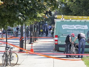 Montreal Police collision investigators look at a bicycle that was involved in a collision with the truck in the photo on Berri St. between Ontario St. and De Maisonneuve Blvd. in Montreal Friday August 26, 2016.
