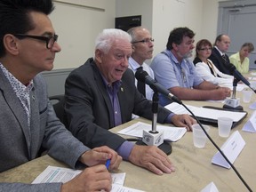 The mayor of Lanoraie, Gérard Jean, second from left,  speaks next to other Quebec regional mayors, during press conference to show their opposition to Bill 106, while in Montreal on Friday August 26, 2016.