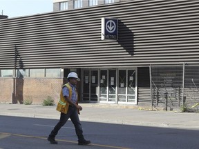 An official walks by the former Montreal bus terminal Wednesday, August 3, 2016. There was an unstable wall risking collapse.