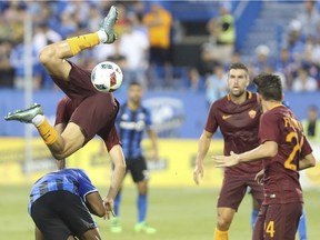Kostas Manolas of the Italian club AS Roma flies out of control in a collision with Didier Drogba in an international friendly soccer game Wednesday, August 3, 2016 at Saputo stadium in Montreal.