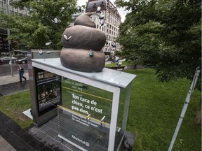 As part of its cleanliness advertising campaign, the city of Montreal has placed a giant pile of plastic dog poop, complete with flies, on top of a bus shelter at the northeast corner of Peel and René-Lévesque in Montreal, on Wednesday, August 31, 2016.