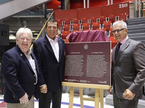 Stéphane Lauzon, right, Parliamentary Secretary for Sport and Persons with Disabilities, with former players Pat Stapleton, left and Serge Savard, at the Montreal Forum, unveiling a commemorative plaque highlighting the national historic significance of the 1972 Summit Series on August 31, 2016.
