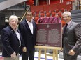 Stéphane Lauzon, right, Parliamentary Secretary for Sport and Persons with Disabilities, with former players Pat Stapleton, left and Serge Savard, at the Montreal Forum, unveiling a commemorative plaque highlighting the national historic significance of the 1972 Summit Series on August 31, 2016.