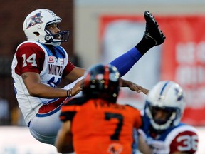 Montreal Alouettes kicker Boris Bede watches the ball as Montreal Alouettes safety Daryl Townsend prevents BC Lions defensive back Eric Fraser from blocking the kick during CFL action at Molson Stadium in Montreal on Thursday August 4, 2016.