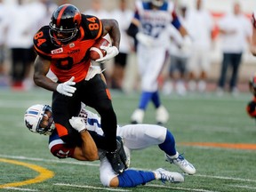 Montreal Alouettes linebacker Chip Cox, bottom, drags BC Lions wide receiver Emmanuel Arceneaux to the turf during CFL action at Molson Stadium in Montreal on Thursday August 4, 2016.