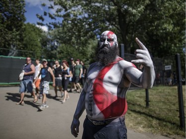 A metal fan poses for a photograph on day one of the Heavy Montréal music festival at Parc Jean-Drapeau Park in Montreal on Saturday, August 6, 2016.