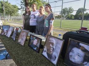 (l-r) Julie Matson, Bridget Tolley, Lilian Villanueva and Dominique Bernier stand in front of photos of their family members who have died at the hands of police during a press conference to denounce the 'police-dominated' Bureau des enquetes independantes (BEI), the new agency in Quebec that investigates police shooting in Montreal, on Tuesday, August 9, 2016.