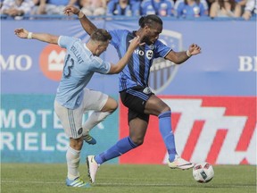 Montreal Impact forward Didier Drogba, right, battles for the ball against New York City FC defender Frederic Brillant, left, during the second half of their MLS soccer match at Saputo Stadium in Montreal on Sunday, July 17, 2016.