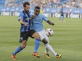 Montreal Impact forward Matteo Mancosu, left, battles for the ball against New York City FC defender Jefferson Mena, right, during the second half of their MLS soccer match at Saputo Stadium in Montreal on July 17, 2016.