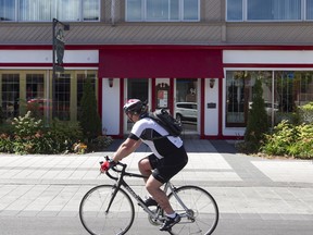 A cyclist pushes past the new restaurant of famed Montreal chef Jérôme Ferrer on Saturday July 30, 2016. He is opening gourmet 'snack shack' in Ste-Anne-de-Bellevue.