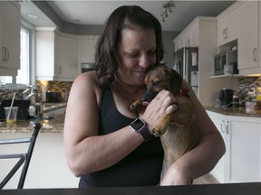 MONTREAL, QUE.: JULY 30, 2016 -- Nathalie Bouchard with her dog Buffy, Saturday July 30 2016, in Kirkland, QC. e Bouchard was walking her dog near Ecclestone Park early the morning of July 27   when her dog was attacked by the coyote that the city has been trying to trap and release. (Robert Amyot / MONTREAL GAZETTE) ORG XMIT: 56792