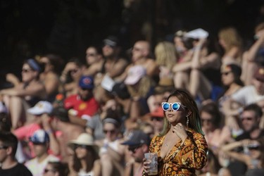 A music fan watches the performance by Canadian musician Grimes on day three of the Osheaga Music Festival at Jean-Drapeau Park in Montreal on Sunday, July 31, 2016.
