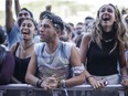 Music fans enjoy the performance by Foals on Day Three of the Osheaga Music and Arts Festival at Parc Jean-Drapeau on Sunday, July 31, 2016.