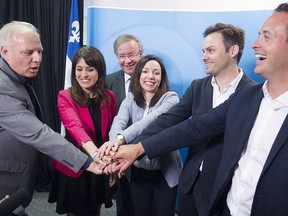 Parti Québécois leadership hopefuls gather around president Raymond Archambault, glasses, at PQ headquarters in Montreal on  Monday July 4, 2016. From left: Jean-François Lisée, Véronique Hivon, Martine Ouellet, Paul Saint-Pierre Plamondon and Alexandre Cloutier.  Hivon has since withdrawn her candidacy for health reasons.