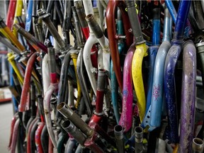 Hundreds of bicycle forks hang on shelving in the spare parts section at SOS Vélo in Montreal in this file photo.
