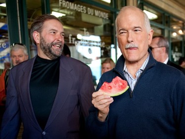 NDP leader Jack Layton, right, walks through the Atwater Market alongside fellow McGill alumnus Thomas Mulcair in 2011. Layton died three months later from prostate cancer and Mulcair became NDP leader the following year.