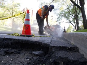 A city worker repairs a section of Glen Road in Westmount May 30, 2012.