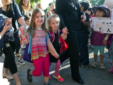 2014: Michaela Christie, left, 5, and 4-year-old Isabelle Sobieraj walk between two lines of older students as they and 54 other new kindergarten students are welcomed on their first day to Clearpoint Elementary School, in Pointe Claire. These stretchy bright-coloured leggings are much more comfortable than the frilly dresses their grandmothers, or great grandmothers, had to wear and no stiff leather shoes on these gals either. Neon-coloured mess running shoes are still going strong to this day.