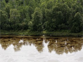 Oil can be seen on the North Saskatchewan river near Maidstone, Sask on Friday July 22, 2016. Husky Energy has said between 200,000 and 250,000 litres of crude oil and other material leaked into the river on Thursday from its pipeline.