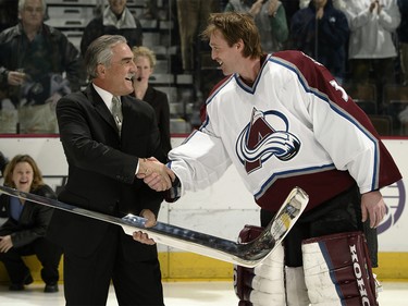 Jan. 20, 2003: Former Kings goaltender Rogie Vachon presents goalie Patrick Roy #33 of the Colorado Avalanche with a silver stick before his 1000th game, at the Pepsi Center in Denver, Colorado.