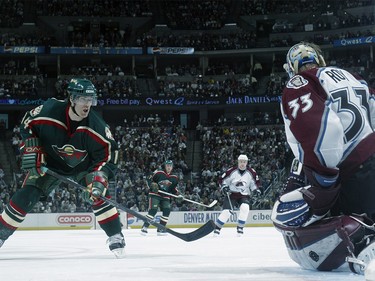 April 10, 2003:  Darby Hendrickson #14 of the Minnesota Wild takes a shot on goaltender Patrick Roy #33 of the Colorado Avalanche during game one in the first round of the NHL 2003 Stanley Cup playoffs at the Pepsi Center in Denver, Colorado.