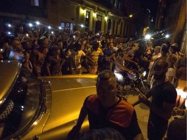 People try to catch a glimpse of Madonna as she arrives at a private restaurant for a party in Havana, Cuba, Tuesday, Aug. 16, 2016.