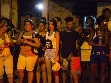 People wait to get a glimpse of as she arrives at a restaurant where she was celebrating her 58th birthday in Havana, Cuba, Tuesday, Aug. 16, 2016.